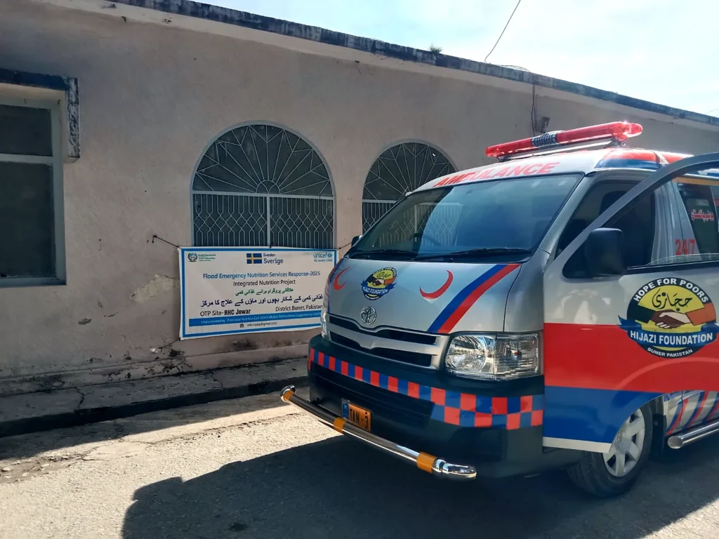 The foundation ambulance parked beside a building.