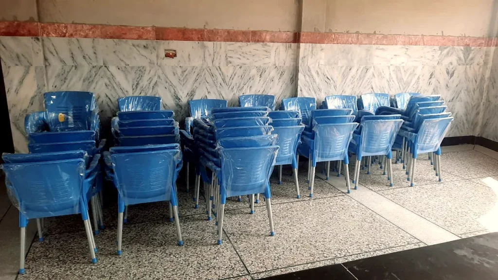 Rows of new blue chairs in a classroom.
